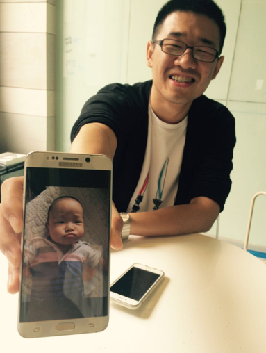 Man showing a photo of his baby